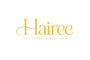 The logo for 'Hairee Premium Wigs' is displayed on a solid white background, featuring the brand name 'Hairee' in a blue cursive font with 'PREMIUM WIGS' written in a smaller, capitalized sans-serif font underneath.